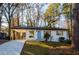 Charming single-story home with a bright blue front door and covered parking at 474 Fairlock Nw Ln, Atlanta, GA 30331