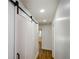 Hallway with barn door and wood-look floors at 474 Fairlock Nw Ln, Atlanta, GA 30331
