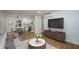Open-concept living room featuring hardwood floors, adjacent to the kitchen and dining area at 474 Fairlock Nw Ln, Atlanta, GA 30331