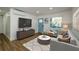 Bright living room with hardwood floors, a blue front door, and a comfortable seating area at 474 Fairlock Nw Ln, Atlanta, GA 30331