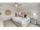 Comfortable bedroom featuring a tray ceiling, neutral decor, and decorative wall art at 443 Village Ln, Fairburn, GA 30213