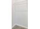 Walk in closet featuring white walls, carpeting, and a metal storage rack on the wall at 443 Village Ln, Fairburn, GA 30213