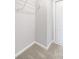 Carpeted closet featuring metal rack, white walls, and a white door at 443 Village Ln, Fairburn, GA 30213