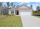 Charming one-story brick home with a well-manicured lawn and attached two-car garage at 443 Village Ln, Fairburn, GA 30213