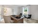 Office with a large desk, comfortable chairs, and natural light at 443 Village Ln, Fairburn, GA 30213