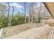 Large wooden deck surrounded by lush greenery, perfect for enjoying nature at 4485 Canary Ct, Lithia Springs, GA 30122