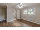 Bedroom showcasing natural light, laminate flooring, a ceiling fan, and an open doorway to the bathroom at 4485 Canary Ct, Lithia Springs, GA 30122