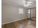 Bedroom featuring laminate flooring, neutral paint, a window, and a mirrored closet at 4485 Canary Ct, Lithia Springs, GA 30122