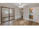 Bright bedroom features hardwood floors, a ceiling fan with lighting, and a mirrored closet, creating a cozy atmosphere at 4485 Canary Ct, Lithia Springs, GA 30122