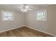 Bedroom with hardwood floors, crown moulding, and two windows providing natural light, creating a serene living space at 4485 Canary Ct, Lithia Springs, GA 30122