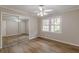 Bedroom with laminate flooring, ceiling fan, and a large mirror closet at 4485 Canary Ct, Lithia Springs, GA 30122