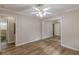 Bedroom features laminate wood flooring, ceiling fan with lights, and mirrored closet at 4485 Canary Ct, Lithia Springs, GA 30122