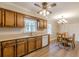 The kitchen features wood cabinets, stainless sink, and a view into the dining area at 4485 Canary Ct, Lithia Springs, GA 30122