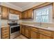 Well-lit kitchen features stainless steel appliances, wooden cabinetry, and a double basin sink at 4485 Canary Ct, Lithia Springs, GA 30122
