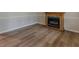 Open living room featuring wood-look floors, a decorative fireplace, and neutral wall paint at 4485 Canary Ct, Lithia Springs, GA 30122
