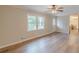 An open floor plan lets plenty of light into this area with wood-look floors and neutral paint at 4485 Canary Ct, Lithia Springs, GA 30122