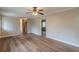 Open living area with new wood-look floors, ceiling fan, neutral paint, and a view into the kitchen at 4485 Canary Ct, Lithia Springs, GA 30122