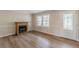 Living room showcases wood-look floors, neutral wall paint, an electric fireplace, and a view into the front yard at 4485 Canary Ct, Lithia Springs, GA 30122