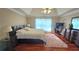 Spacious main bedroom with hardwood floors, large windows, and a plush rug at 725 Cricket Hill Trl, Lawrenceville, GA 30044