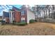 Red brick and white-sided home with landscaping at 725 Cricket Hill Trl, Lawrenceville, GA 30044