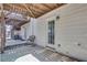 Covered back patio with seating area and walkout access to greenery and trees at 1081 Liberty Pkwy, Atlanta, GA 30318