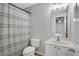 Bathroom displays a white sink, toilet, shower with curtain and view to the bedroom at 1081 Liberty Pkwy, Atlanta, GA 30318