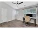Bedroom showcases a ceiling fan, hardwood floor, large window and two closet doors at 1081 Liberty Pkwy, Atlanta, GA 30318