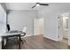 Bedroom features a modern ceiling fan, gray walls, hardwood floor and a bathroom entrance at 1081 Liberty Pkwy, Atlanta, GA 30318