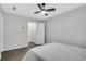 Bedroom boasts a white bed, fan, hardwood floor, and access to a hallway with closets at 1081 Liberty Pkwy, Atlanta, GA 30318