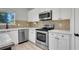 Well-lit kitchen with stainless steel appliances and white cabinets at 1081 Liberty Pkwy, Atlanta, GA 30318
