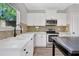 Modern kitchen features white cabinetry, stainless steel appliances, and an island bar at 1081 Liberty Pkwy, Atlanta, GA 30318