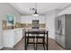 Bright kitchen with stainless steel appliances, island, and gray wood-style flooring at 1081 Liberty Pkwy, Atlanta, GA 30318