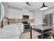 Well-lit kitchen with white cabinets, an island bar, and stainless steel appliances at 1081 Liberty Pkwy, Atlanta, GA 30318