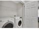 Laundry room includes a washer, dryer, storage shelves and white walls at 1081 Liberty Pkwy, Atlanta, GA 30318