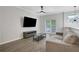 Living room featuring an entertainment center, sofa, and access to balcony at 1081 Liberty Pkwy, Atlanta, GA 30318