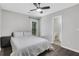 Main bedroom displays a bed, hardwood floor, fan, door to the backyard, and access to a bathroom at 1081 Liberty Pkwy, Atlanta, GA 30318