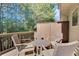 Relaxing outdoor deck area featuring comfortable seating, and views of mature trees at 1081 Liberty Pkwy, Atlanta, GA 30318