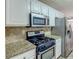 Kitchen with granite countertops and stainless steel appliances at 1624 Graystone Dr, Hampton, GA 30228
