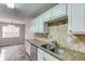 Kitchen with granite countertops and stainless steel appliances at 1624 Graystone Dr, Hampton, GA 30228