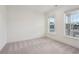 Bright bedroom with neutral walls and carpet flooring; two large windows at 615 Grassmeade Ln, Woodstock, GA 30188