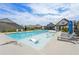 Community pool with lounge chairs and umbrellas at 615 Grassmeade Ln, Woodstock, GA 30188