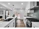 Modern kitchen with stainless steel appliances, quartz countertops, and sleek black hardware at 3290 Ethan Dr, Marietta, GA 30062