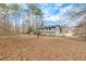 Exterior view of the home with a large backyard with trees at 336 Adelene Way, Dallas, GA 30157