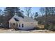Newly constructed home with white siding, wooden porch, and inviting outdoor space, ready for personalization at 41 Walnut Trl, Cartersville, GA 30121