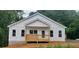 Charming new construction home with white siding, covered front porch, and beautifully wooded surroundings at 41 Walnut Trl, Cartersville, GA 30121