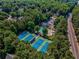 Picturesque aerial view of community tennis courts, pool, clubhouse, and green surroundings at 1506 Brookridge Dr, Woodstock, GA 30189