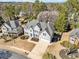 Stunning aerial view of a charming home with well-maintained landscaping, driveway, and surrounding trees at 1506 Brookridge Dr, Woodstock, GA 30189