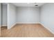 Finished basement with wood flooring, base molding, and neutral walls at 1506 Brookridge Dr, Woodstock, GA 30189
