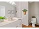 Well-lit bathroom features a white vanity, framed mirror, neutral paint, and decorative touches, offering a clean and comfortable space at 1506 Brookridge Dr, Woodstock, GA 30189
