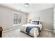 Cozy bedroom featuring a comfortable bed, a window with blinds, and soft carpet at 1506 Brookridge Dr, Woodstock, GA 30189